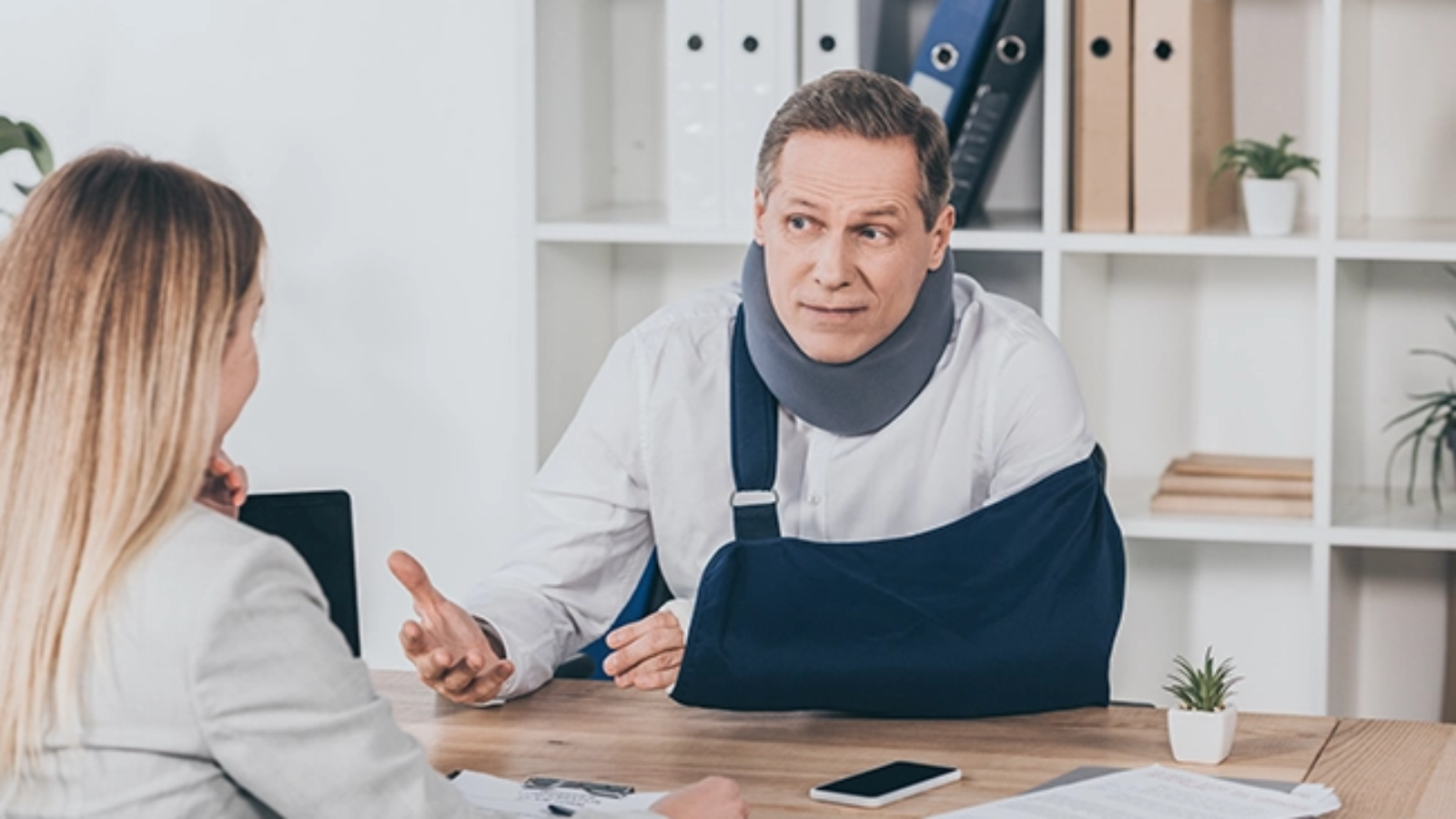 middle-aged-worker-in-neck-brace-with-broken-arm