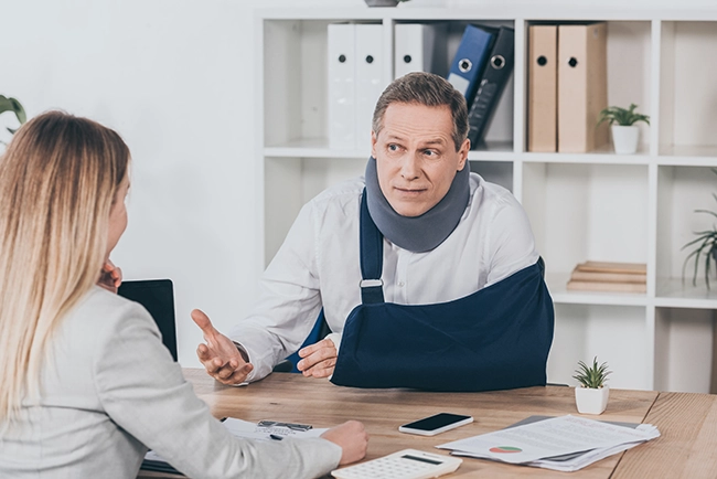 middle-aged-worker-in-neck-brace-with-broken-arm